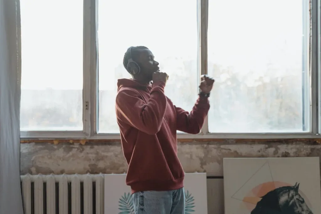 Person freely dancing to hard techno music in their living room.