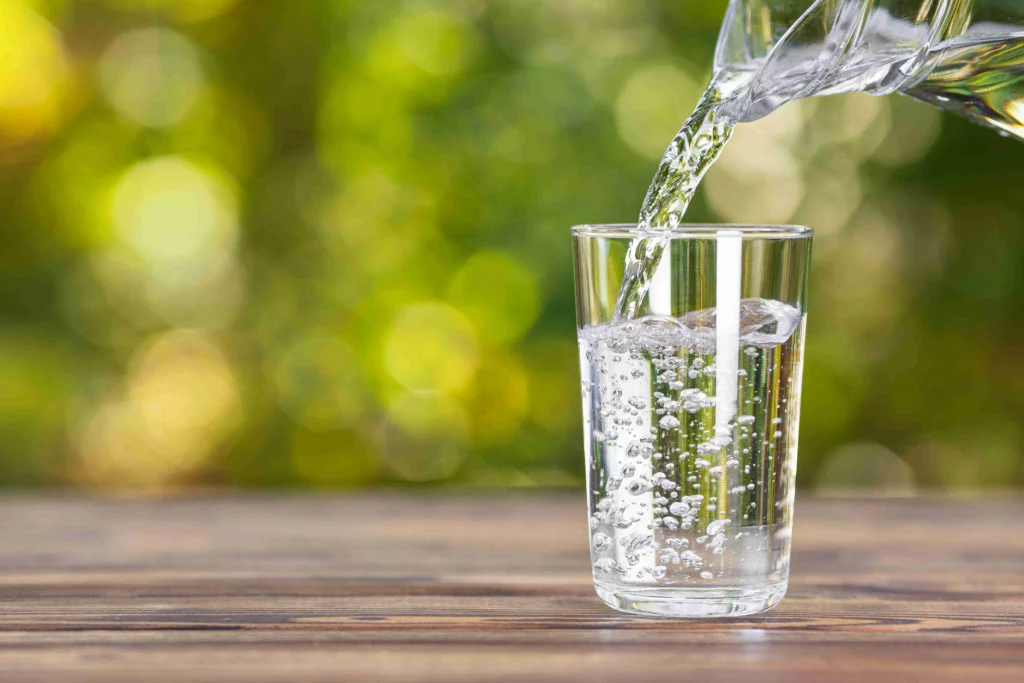 poring water in glass after festival