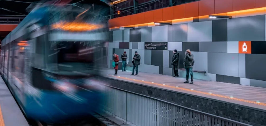 Ravers travelling by train or bus at night on their way to a hard techno festival