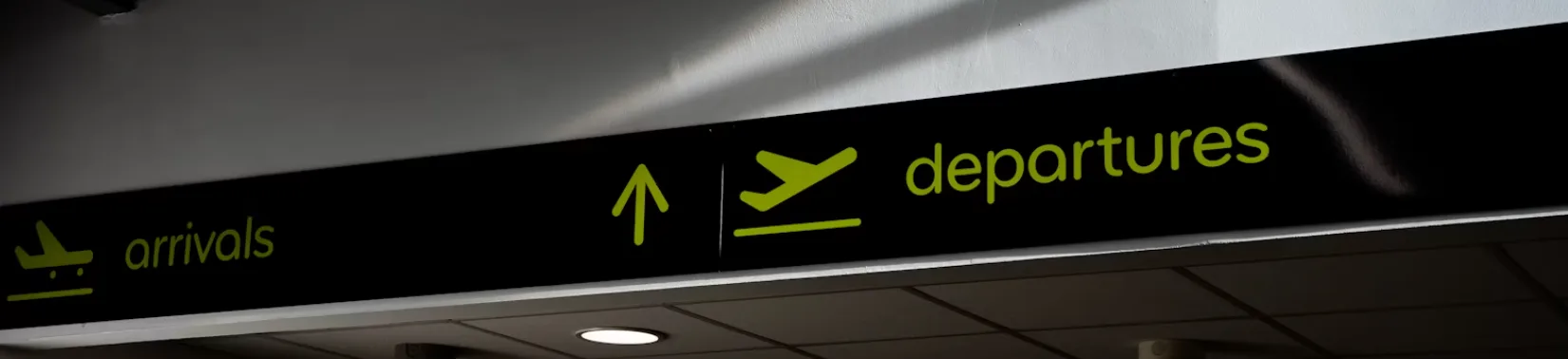Traveler walking through a European airport at night on the way to a hard techno festival
